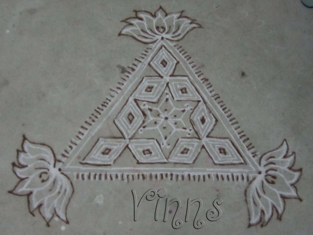 Triangular kolam with lotus pendants.